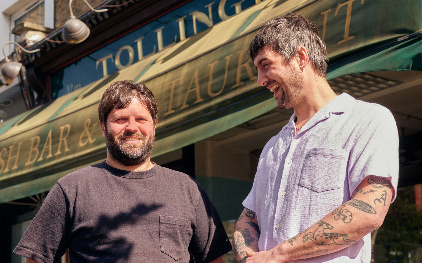 two men standing outside Tollington's